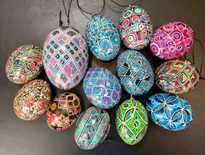 a selection of pysanky, or batik-dyed eggs, with messages in stylized semaphore