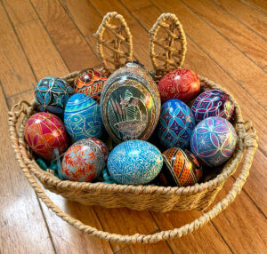 a selection of dyed eggs in a basket