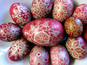 a selection of red and white pysanky, or batik-dyed eggs